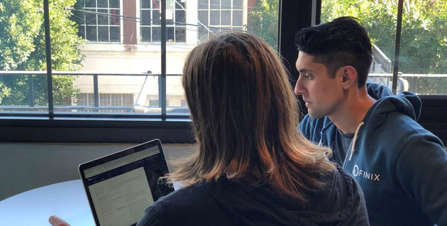 Two people working together on the laptop