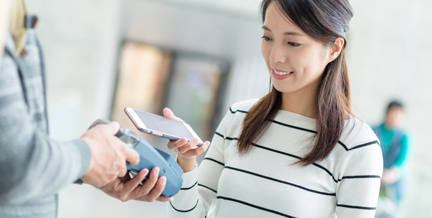 Women holding mobile ph and smiling