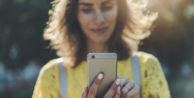 Women smiling and looking at mobile